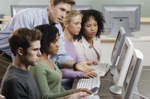 Instructor with Students in Computer Lab --- Image by © Royalty-Free/Corbis